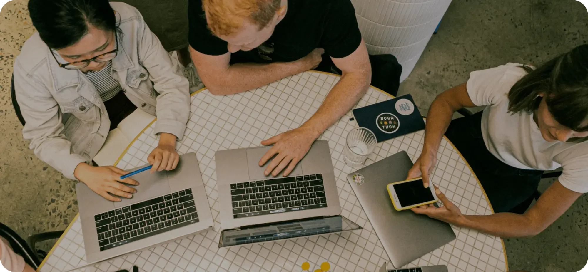 A team working on laptops around a table